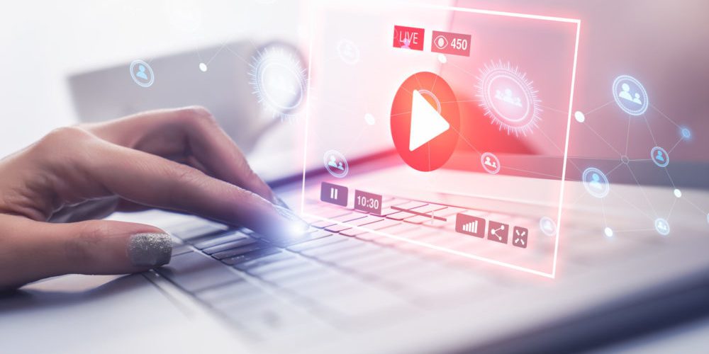 Woman hand using modern laptop computer to connect with live streaming video on social network